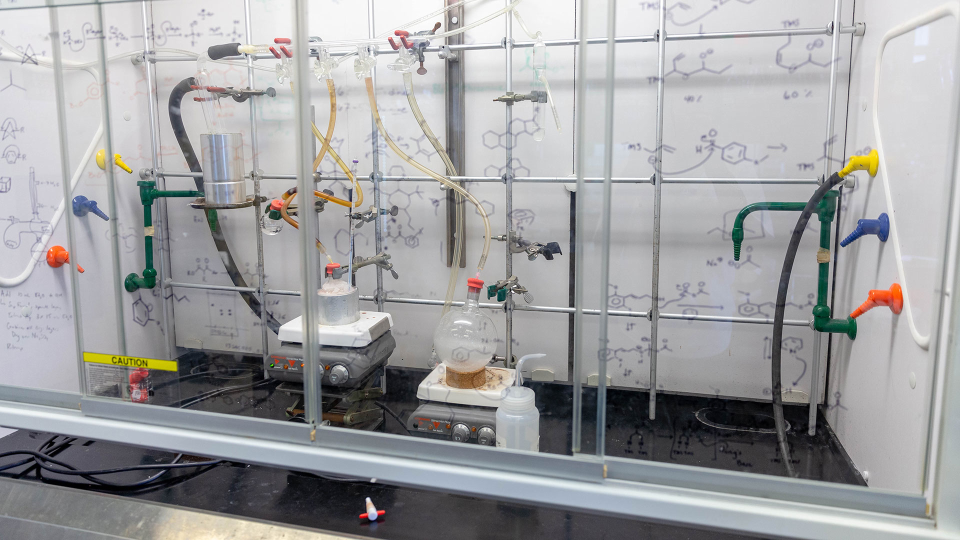 Chemicals in lab under a fume hood