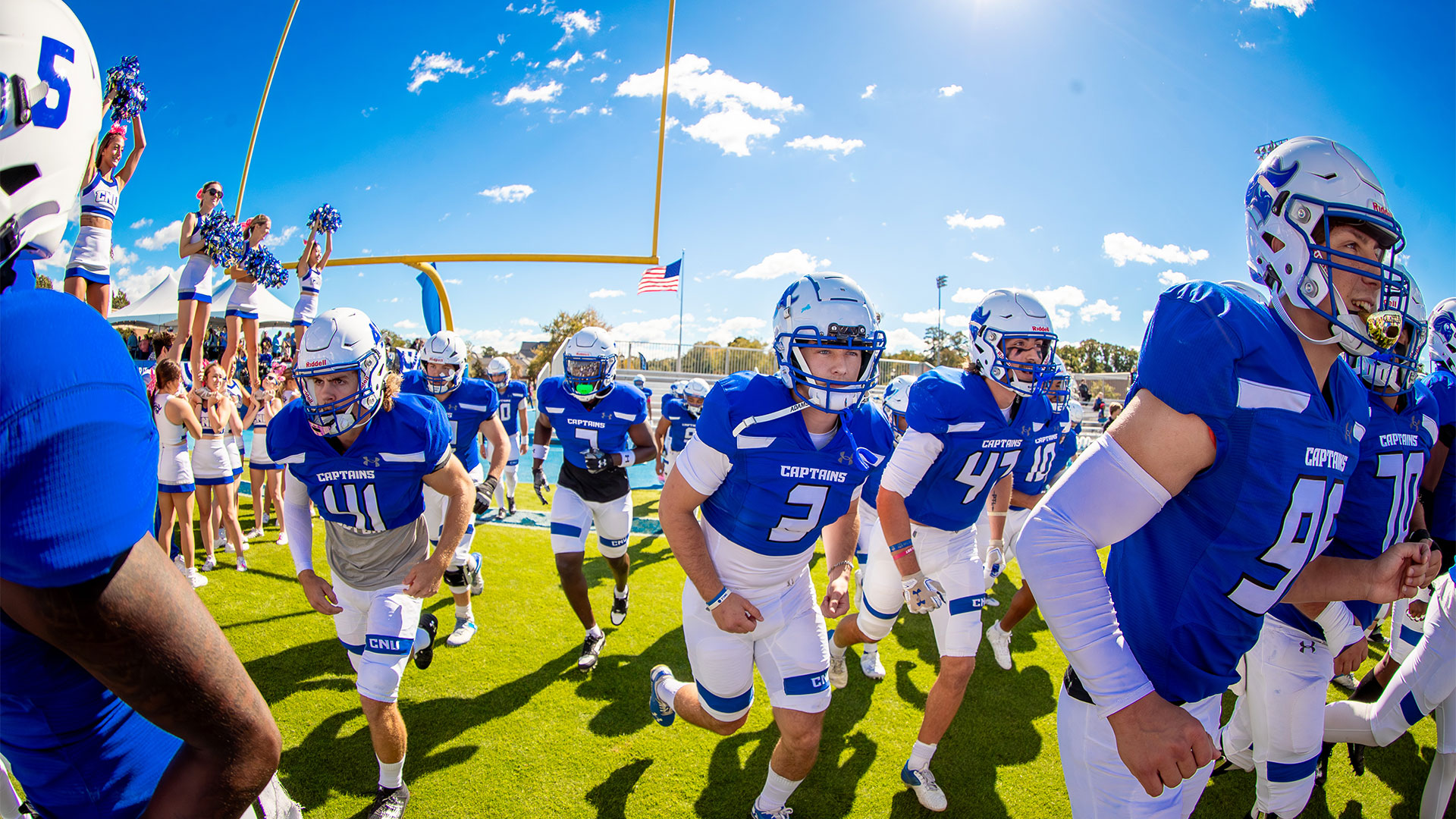 CNU football team and cheerleaders on the football field.