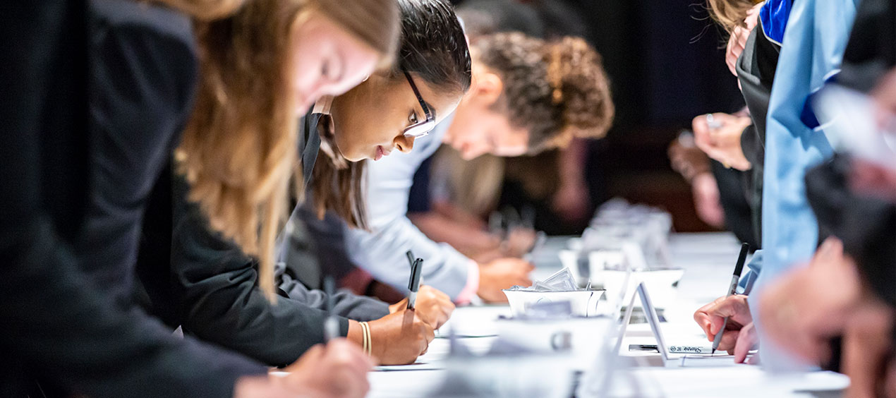 Students signing the honor agreement at convocation