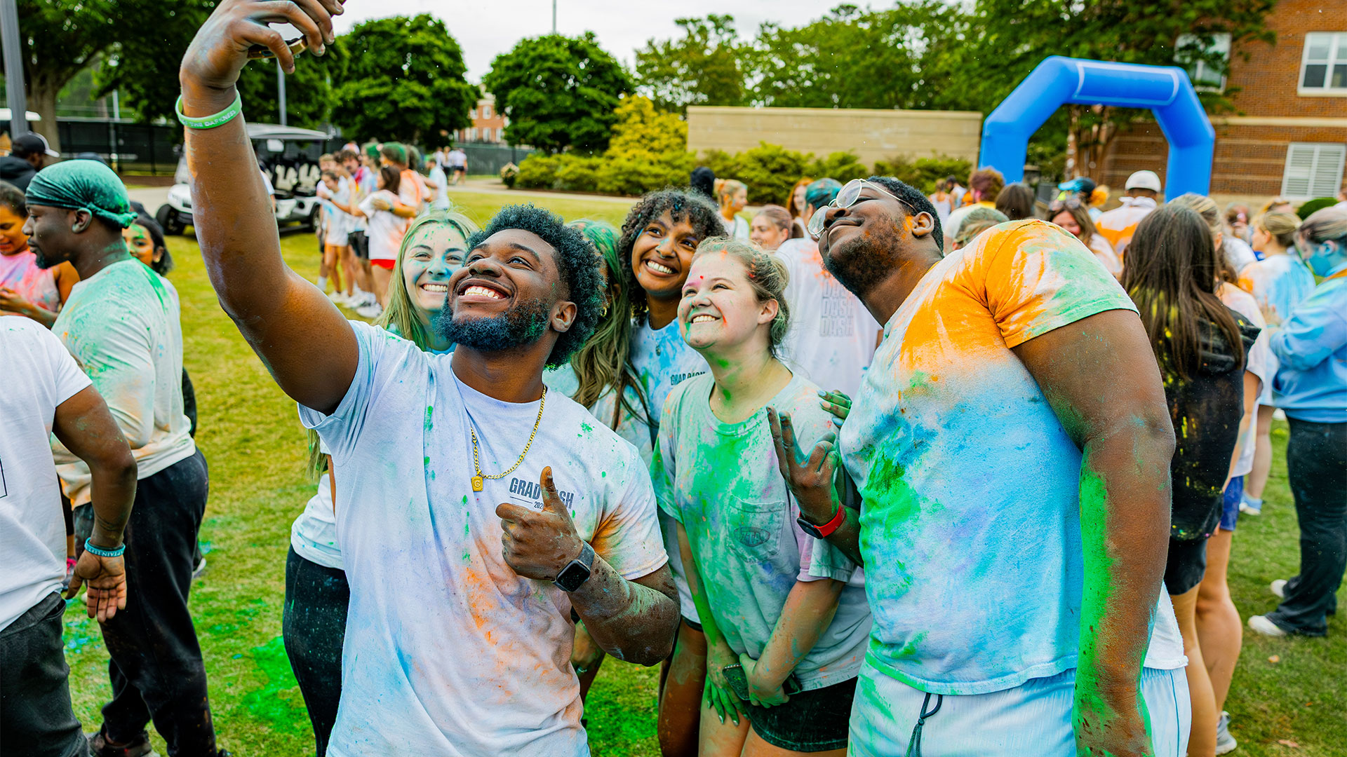 Paint covered students pose for a photo at CNU Grad Dash 2026.
