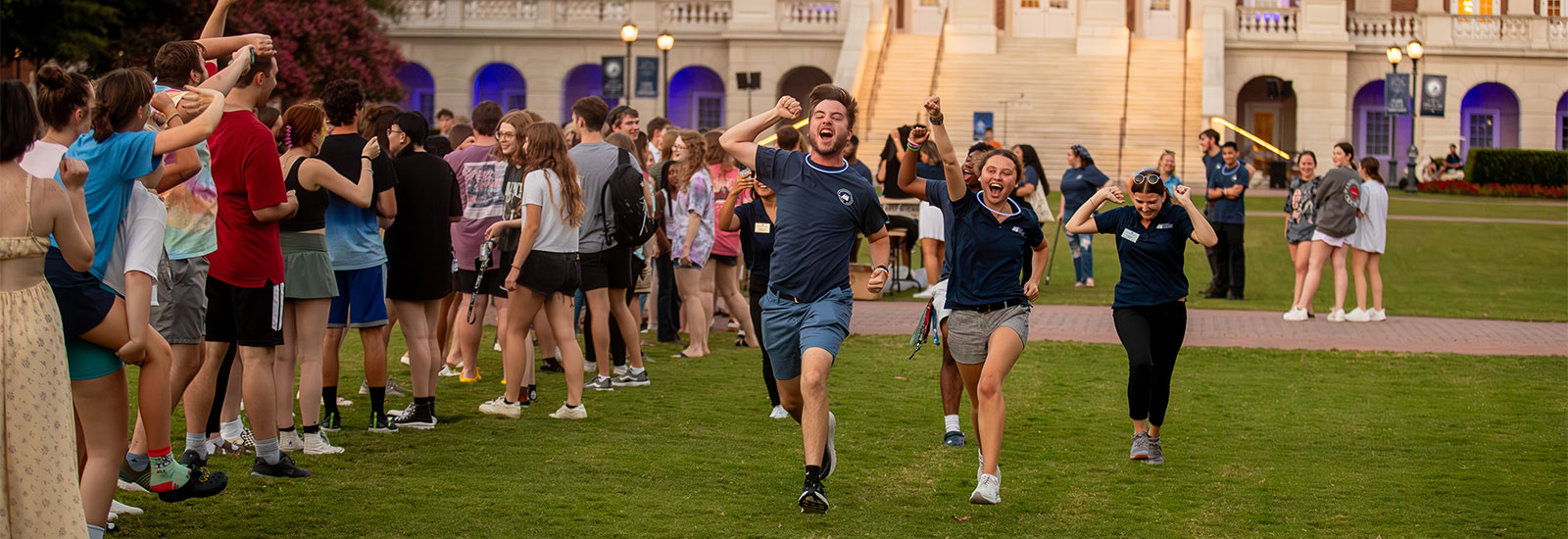 Members of CNU's Student Government Association run cheering down the great lawn during a Student Block Party.