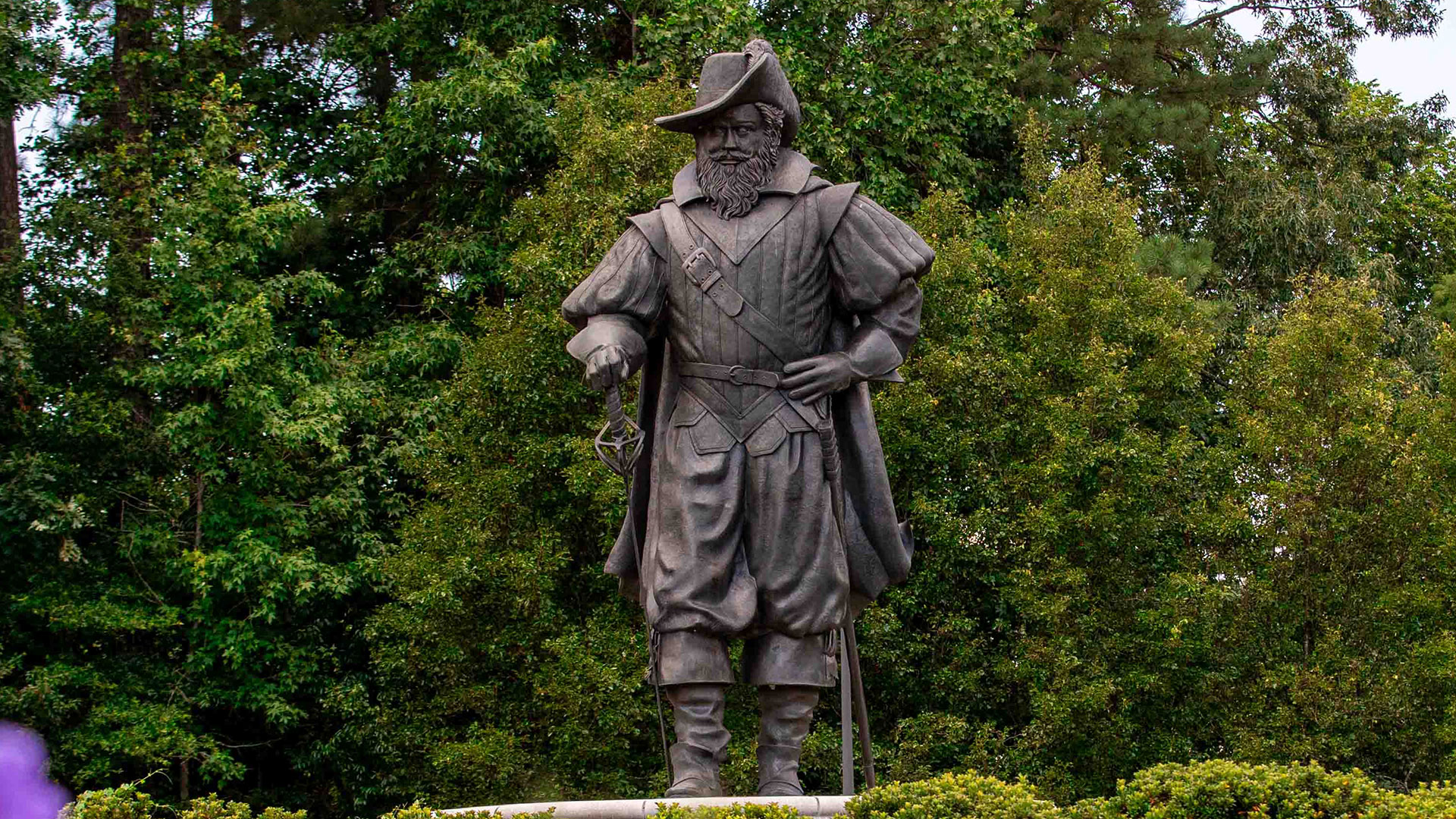 A statue of Captain Chris amongst greenery