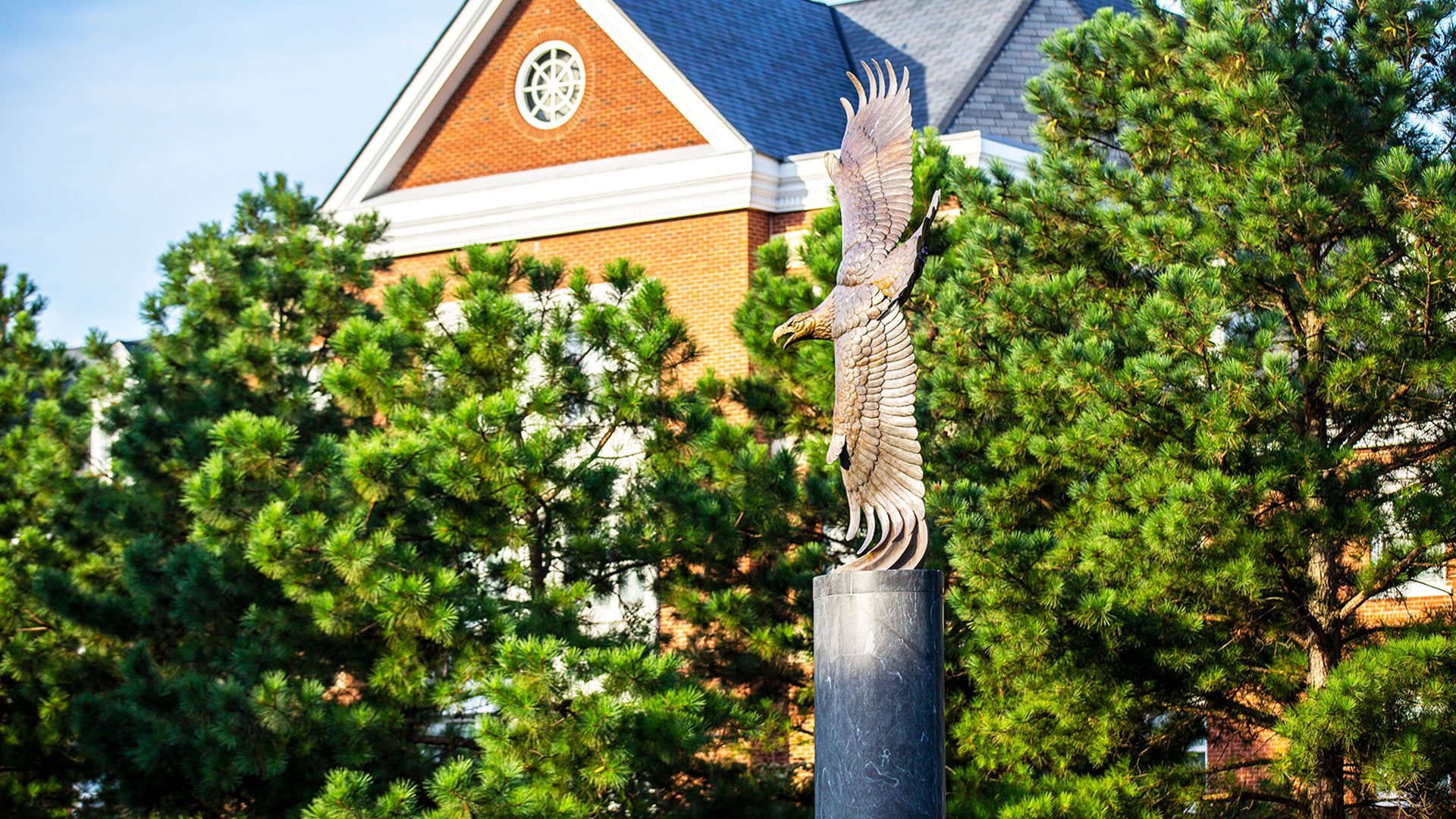 A bronze statue of an eagle soaring.