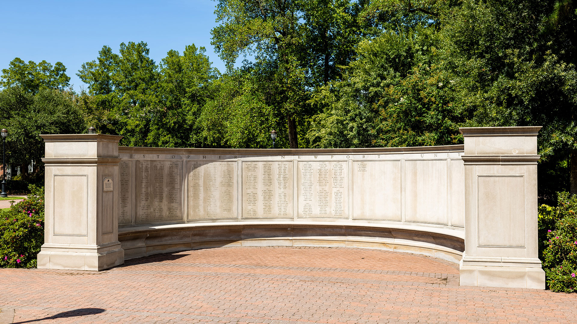 A u-shaped wall with faculty and staff names engraved