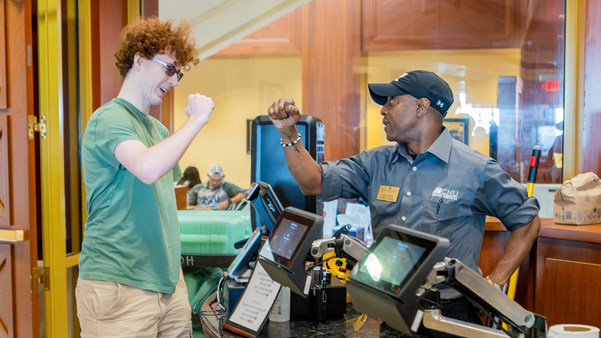 Dana fistbumping a student