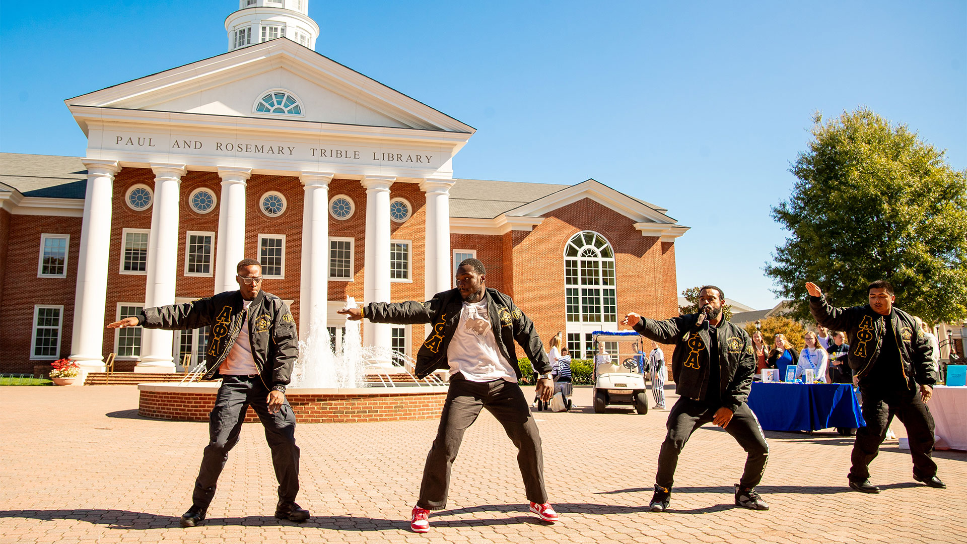 Greek Alphas stroll outside of Trible Library.